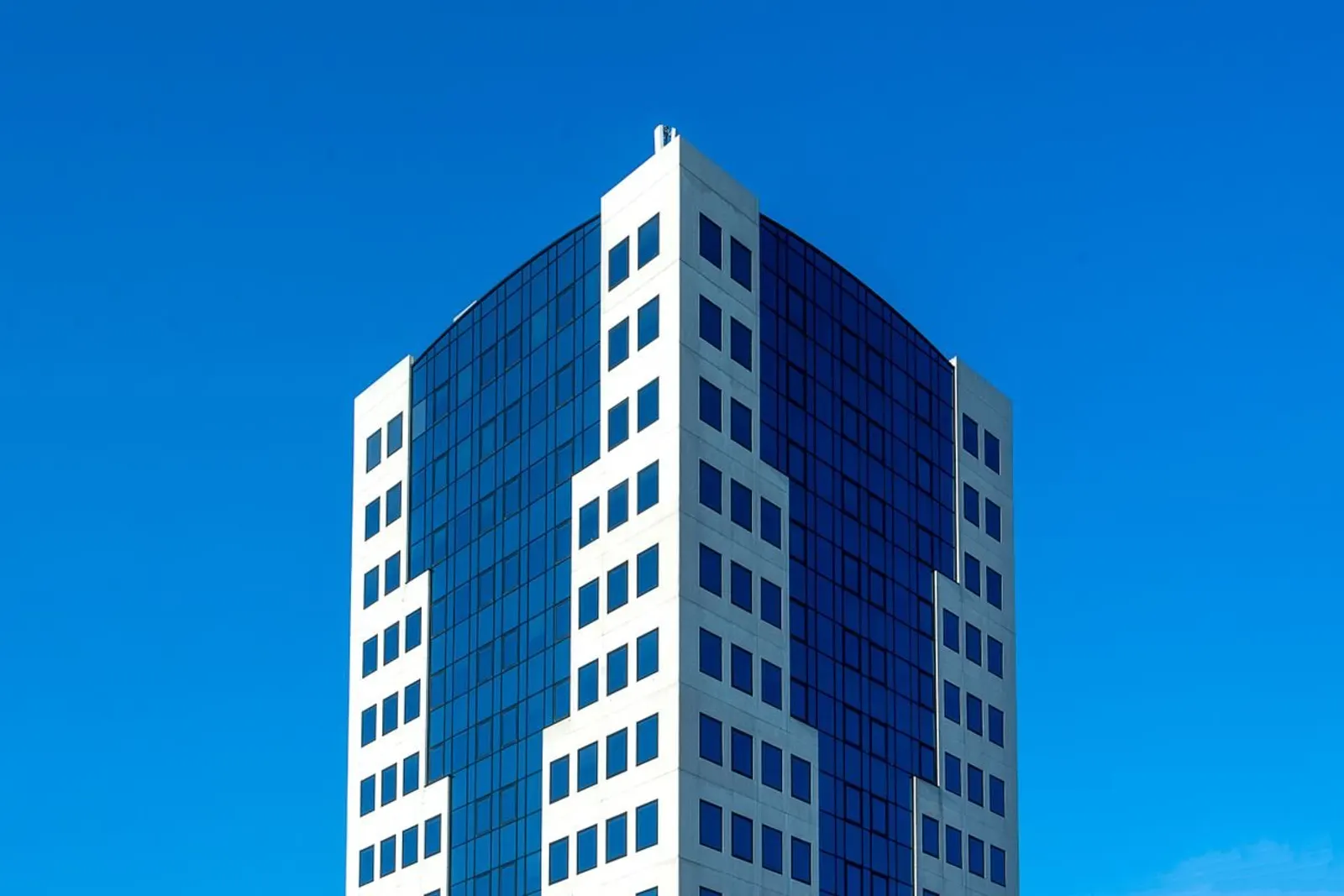Modern office facade with reflective glazing — illustrative commercial photograph