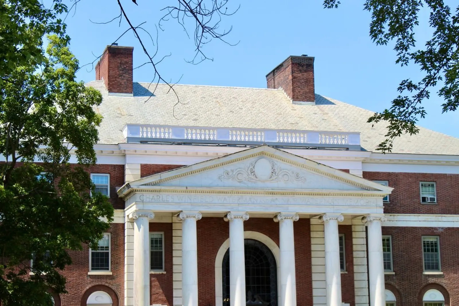 Brick university campus building with columns — illustrative education photograph